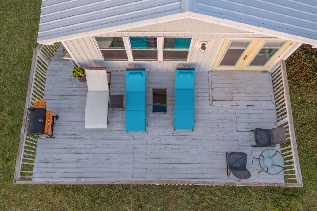 Aerial drone photo directly above back porch with outdoor furniture.