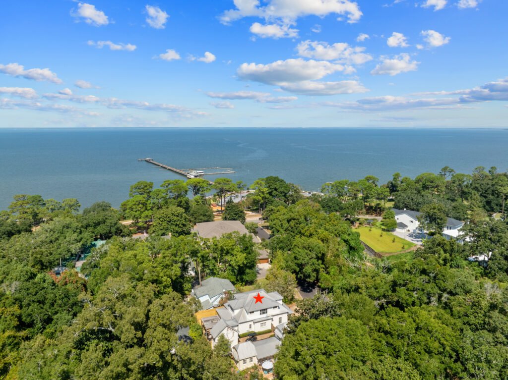 Drone photo showing Emerson House Fairhope, marked with red star, one block from Mobile Bay and Fairhope Pier.