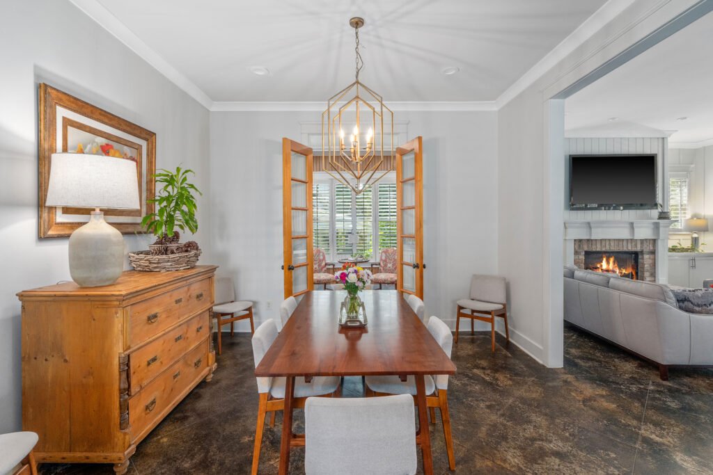 Dining room with walnut dining table and matching chairs. Open floor plan accesses to living room.