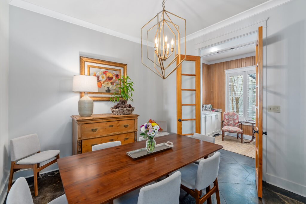 Close up of walnut dining room table and matching chairs seats 10. Access study through french doors.