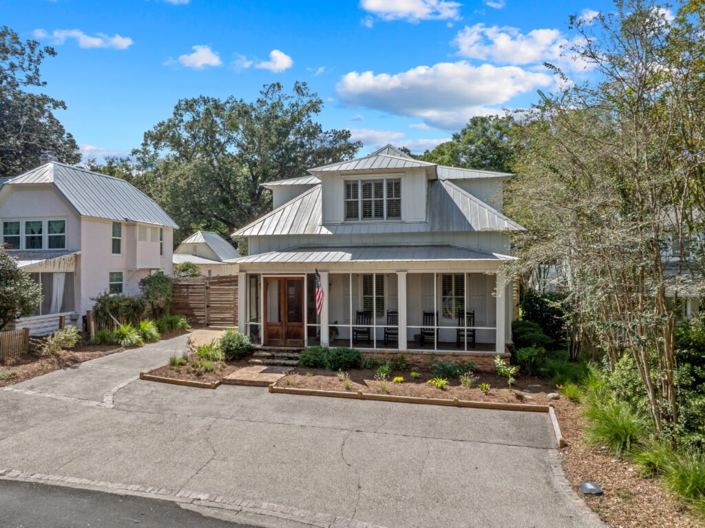 Beautiful exterior photo of luxury cottage on Mobile Bay with Crepe Myrtles, private porch and blue skies.