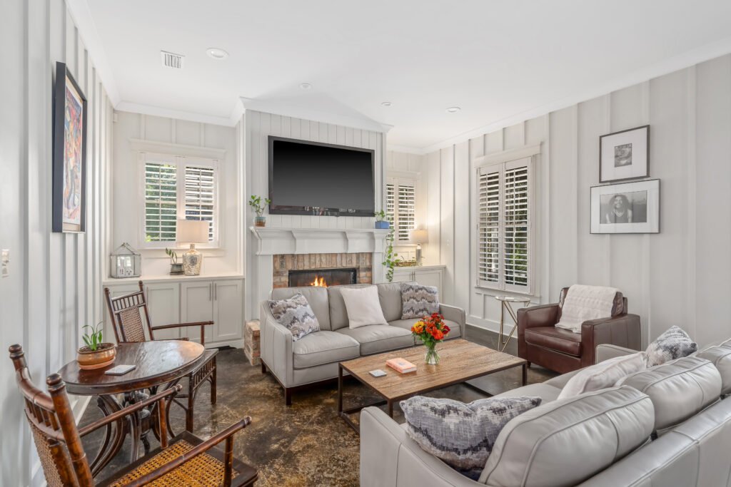 Living room with luxury seating and large TV over mantle.
