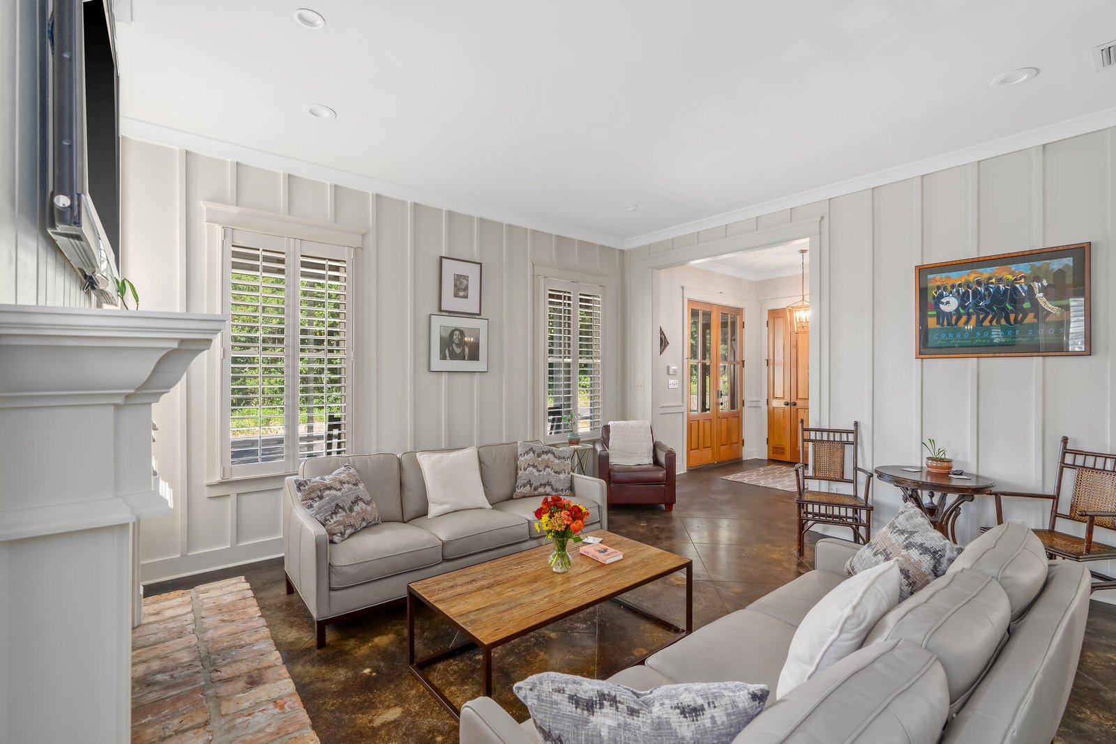 Batten walls, mantle, wood doors and driftwood coffee table are synonymous with Fairhope cottage rentals