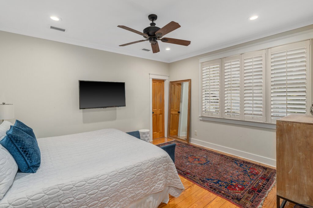 Fourth bedroom upstairs with clearcoated pine hardwood floors.