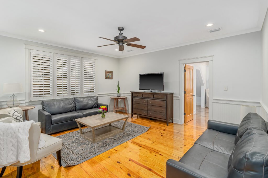 Leather sofas, TV, dresser and coffee table in second living room located upstairs.