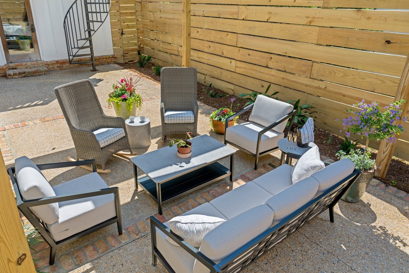 Wide view of Emerson House back patio with seating and privacy fence