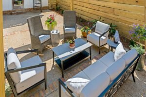 Full back patio layout with furniture and flower pots at Emerson House