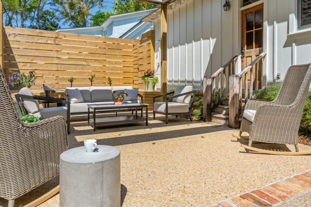 Cushioned outdoor loveseat and chairs on Emerson House back patio