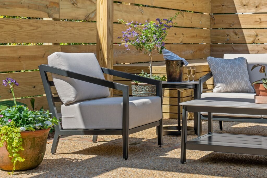 Outdoor patio with rocking chair and potted plants at Emerson House